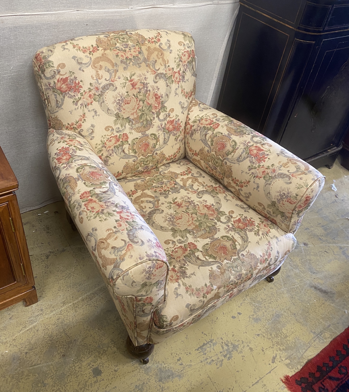A pair of early 20th century upholstered armchairs, width 82cm, depth 86cm, height 76cm
